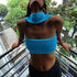 Woman wearing a bright blue ribbed knit bandeau crop top with matching choker, modern streetwear style