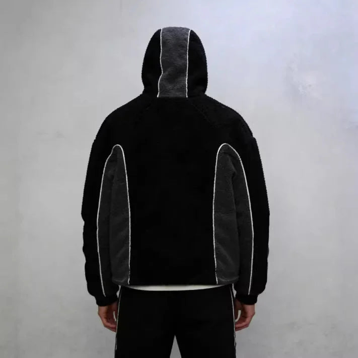 Back view of a black and grey fleece hoodie with contrast piping, relaxed fit streetwear style