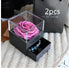Black gift box with clear lid displaying pink preserved rose, drawer holding beaded bracelet