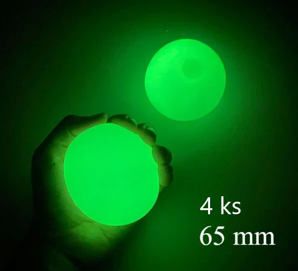 Hand holding glowing green ball, 65mm size, in dark setting, luminous accessory