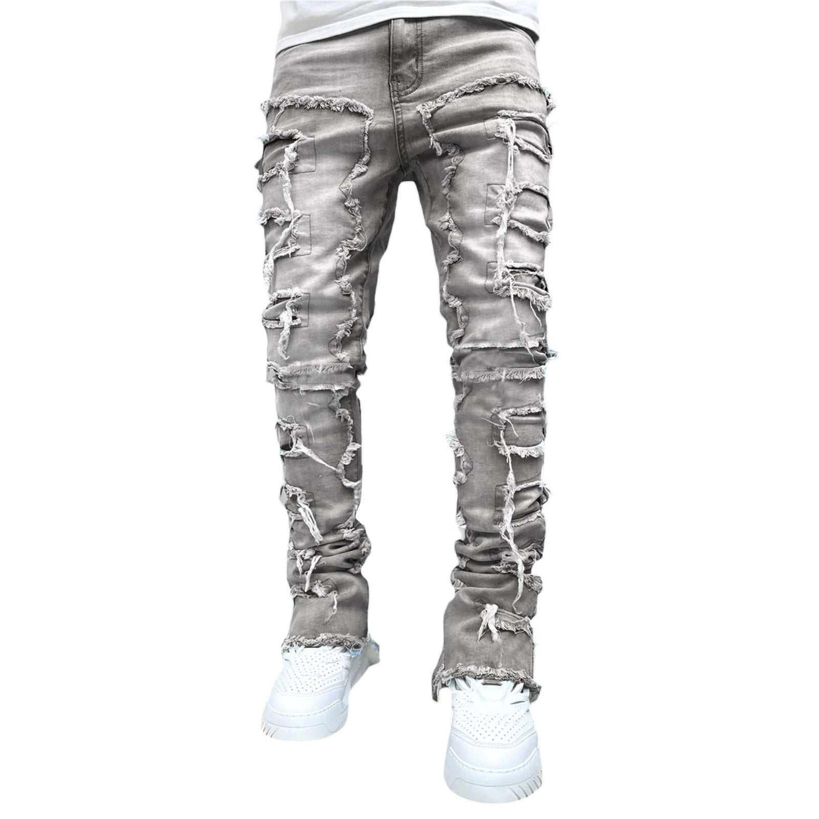 Gray distressed skinny jeans with heavy ripped details and frayed hems, streetwear style