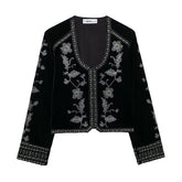 Black velvet jacket with silver floral embroidery, relaxed fit, long sleeves.