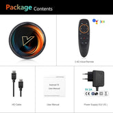 Android TV box set with circular device, black voice remote, HDMI cable, user manual, and power adapter.
