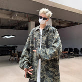 Person wearing oversized camouflage digital print jacket with loose fit streetwear style indoors.