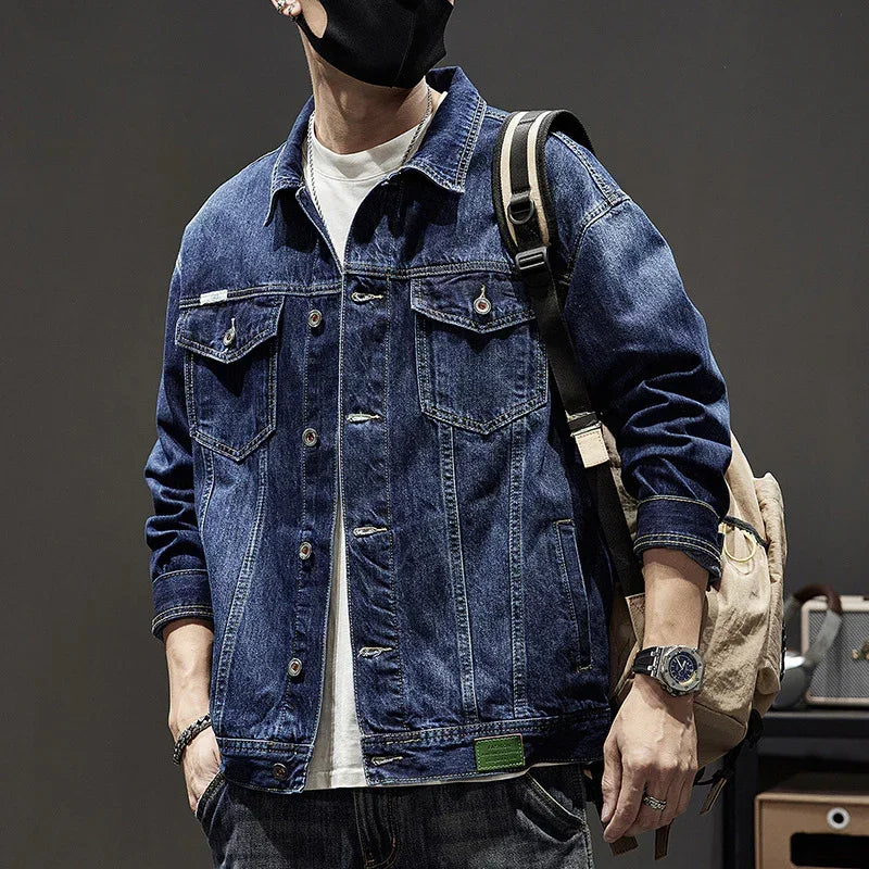 Men's blue denim jacket with button front, relaxed fit, and chest pockets, streetwear style