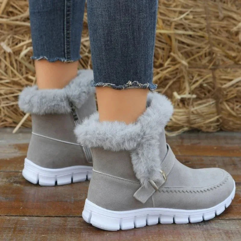 Gray faux fur ankle boots with suede finish, white soles, paired with frayed skinny jeans