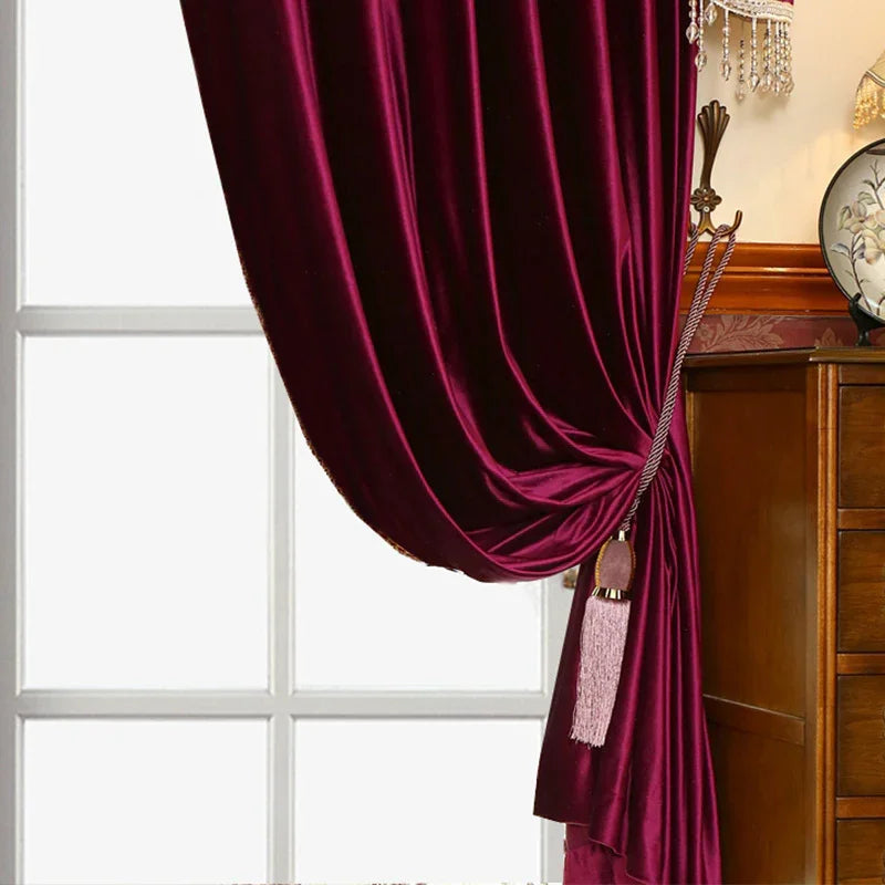Rich burgundy velvet curtain draped and tied, luxury home decor, soft fabric texture