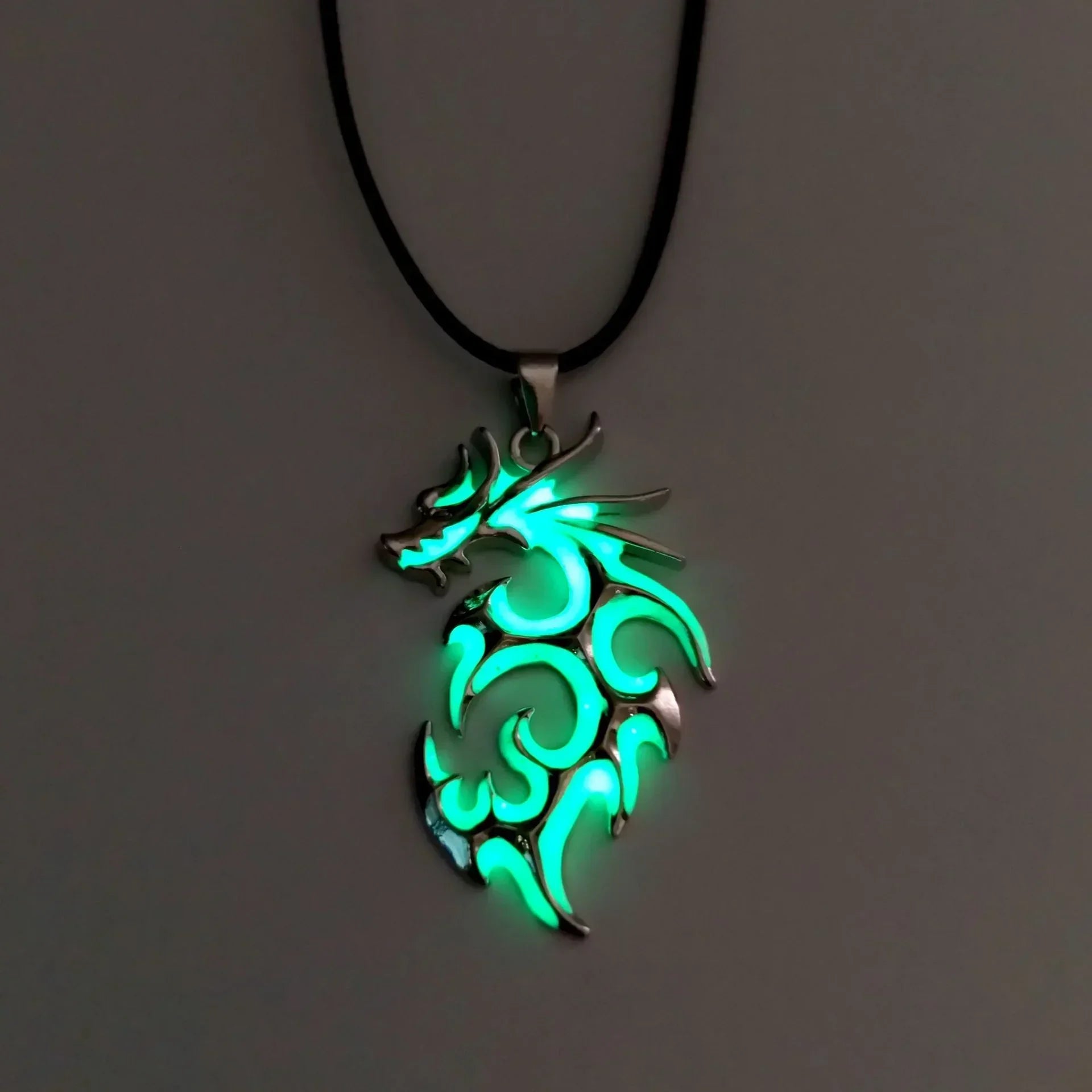 Glow in the dark dragon pendant necklace with metallic finish and black cord, futuristic streetwear accessory