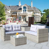 Gray wicker patio sofa set with light cushions, modern outdoor seating on tiled terrace.