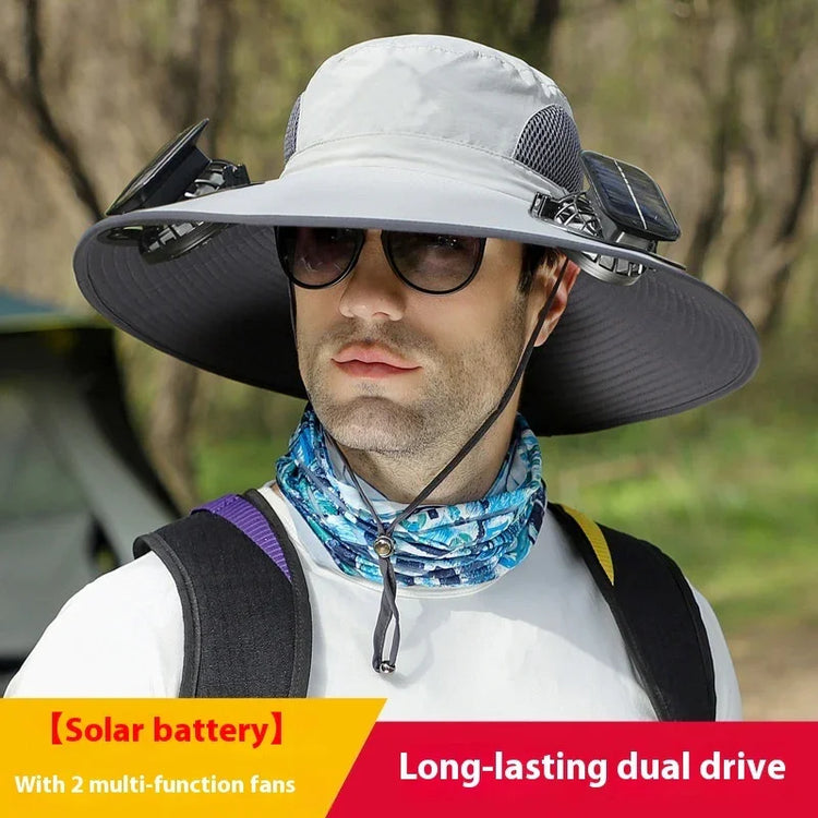 Man wearing wide-brim gray sun hat with solar panels and dual fans, outdoor streetwear style.
