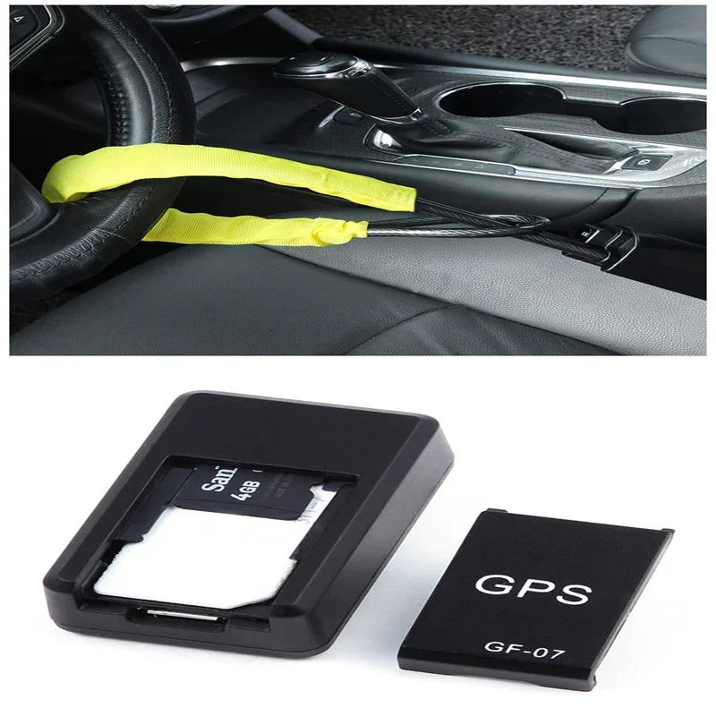 Yellow car steering wheel lock installed, and close-up of a black GPS tracking device with a memory card.