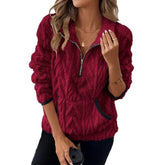 Woman wearing a red textured fleece pullover with half-zip, long sleeves, and relaxed fit