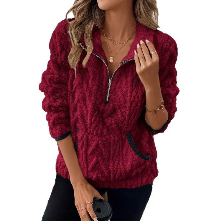 Woman wearing a red textured fleece pullover with half-zip, long sleeves, and relaxed fit