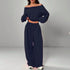 Woman wearing navy blue off-shoulder long sleeve top and wide-leg lounge pants set