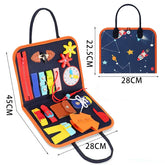 Space-themed busy board activity case with colorful fabric fasteners, zippers, and buttons for kids, portable design, navy blue and orange, educational toy.