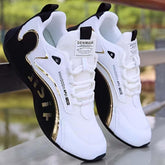 White and black mesh sneakers with gold accents, athletic fit, modern streetwear style