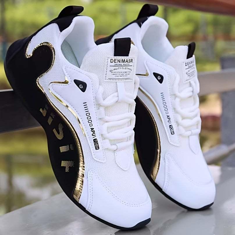 White and black athletic sneakers with gold trim, mesh material, modern streetwear style
