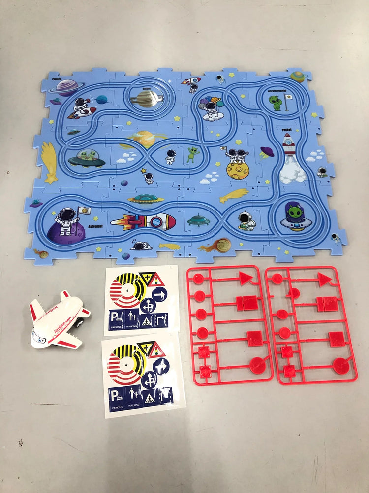 Children’s space-themed play mat with astronaut graphics, toy spaceship, stickers, and red plastic sign pieces.