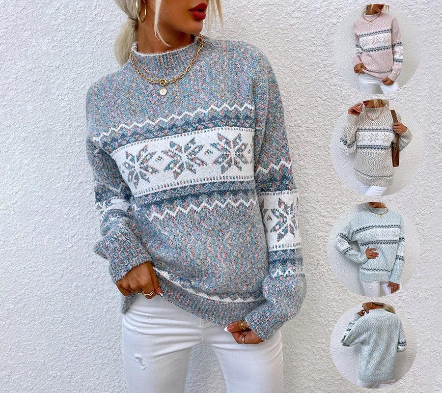 Women’s loose fit knit sweater featuring a blue and white snowflake pattern, long sleeves, crew neck, and soft textured material paired with white jeans.