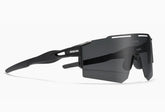 Futuristic black wraparound sunglasses with large tinted lens and angular design, sporty fit