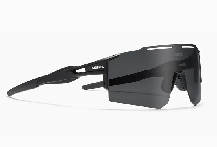 Futuristic black wraparound sunglasses with large tinted lens and angular design, sporty fit