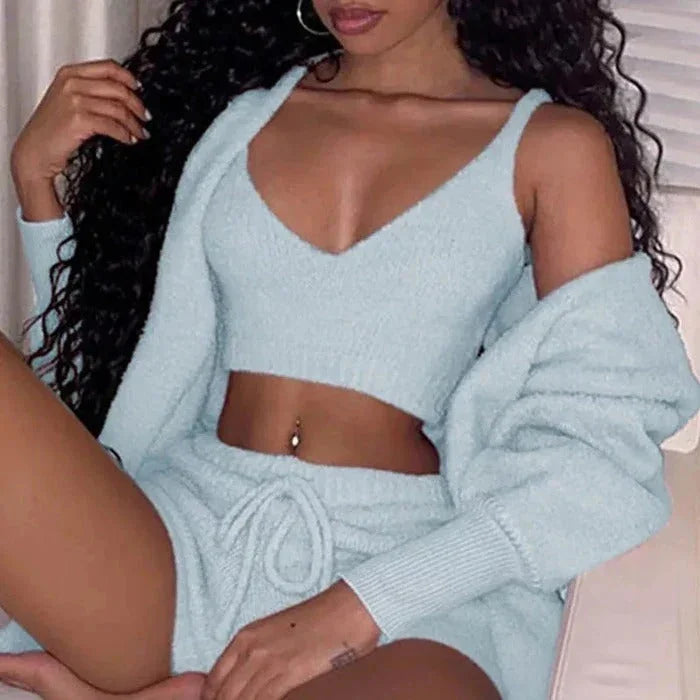 Woman in light blue fuzzy knit crop top, cardigan, and drawstring shorts lounge set