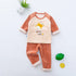 Soft velvet toddler pajama set with striped cream top, cartoon giraffe print, and orange pants.