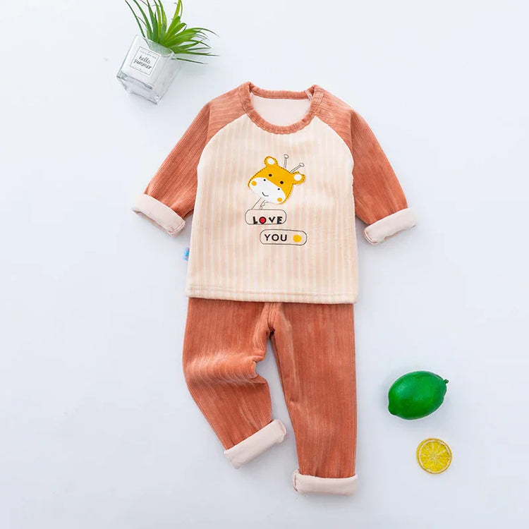 Soft velvet toddler pajama set with striped cream top, cartoon giraffe print, and orange pants.