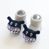 Cute baby socks in cream color with soft ribbed material and playful cartoon face accents