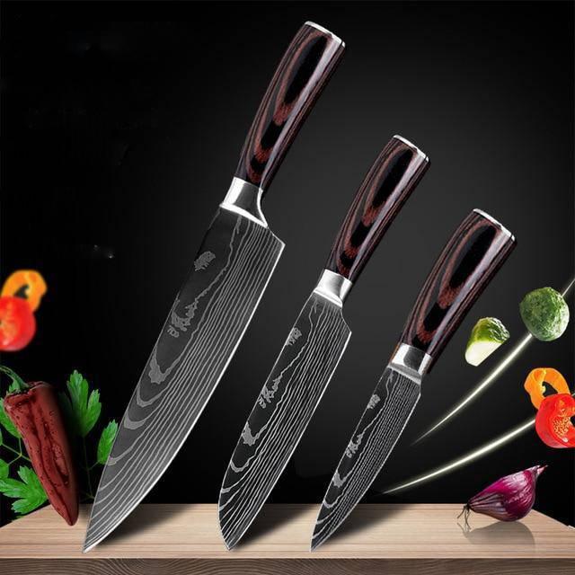 Set of three Damascus steel kitchen knives with dark wood handles on black background