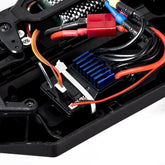 Close-up of RC car electronic components with blue heatsink and colorful wires