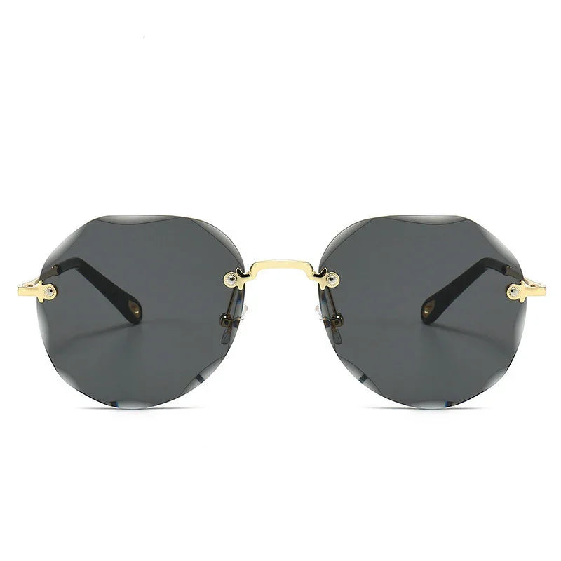 Geometric black rimless sunglasses with gold metal arms and nose bridge, modern streetwear style