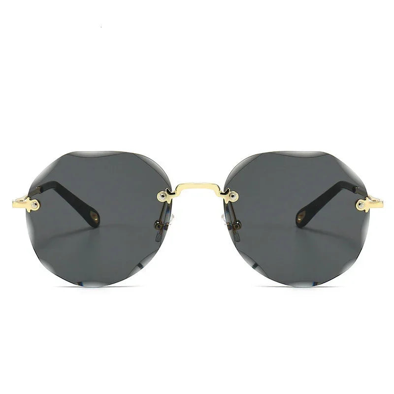Geometric black rimless sunglasses with gold metal arms and nose bridge, modern streetwear style