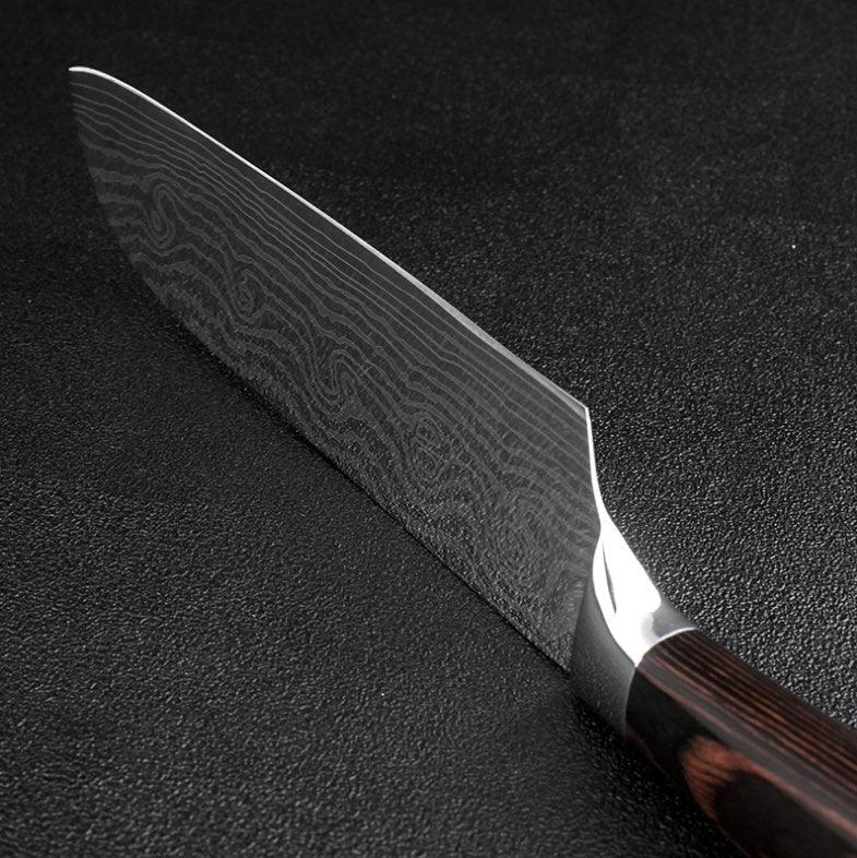 Close-up of a Damascus steel kitchen knife with a dark wood handle on black textured surface