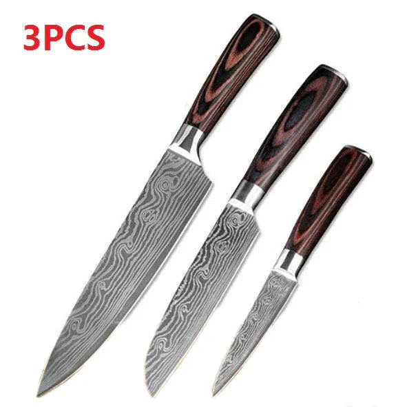 Set of three Damascus steel kitchen knives with wood grain handles on white background