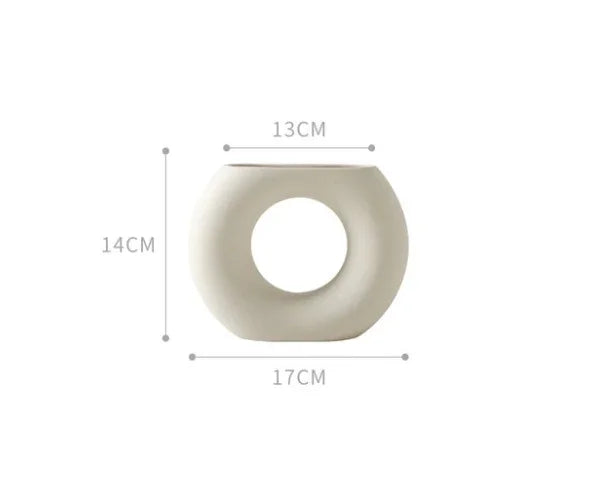 Minimalist white ceramic vase with circular open center, 14cm tall, 17cm wide, 13cm deep.