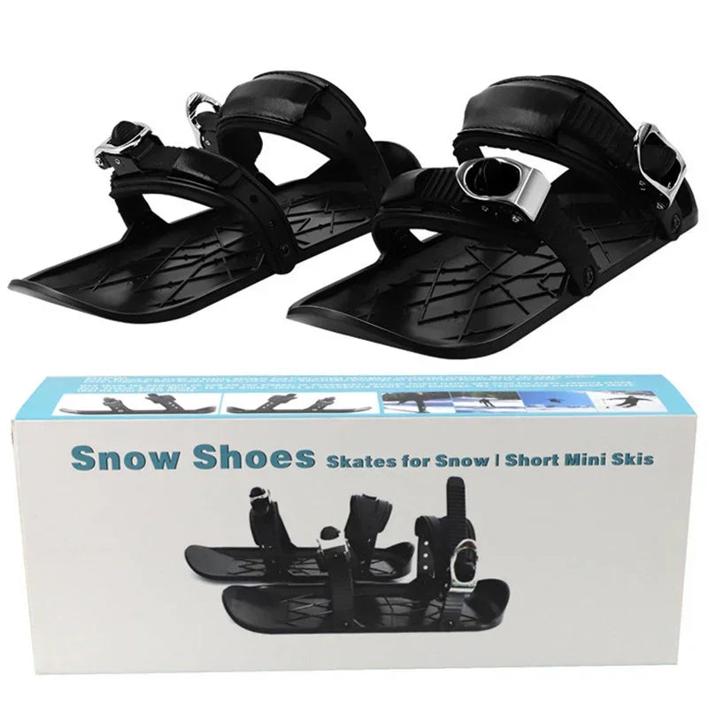 Black plastic snow shoes with adjustable straps, short mini ski design, displayed with packaging.