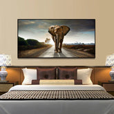 Modern bedroom with a large wall art of an elephant walking on a road, decorative bedding, and patterned lamps