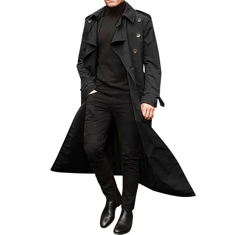 Man in long black trench coat, slim fit turtleneck, and black pants, modern streetwear style