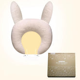 Beige ergonomic baby pillow with cute ear design, soft textured fabric, and supportive fit.