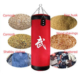 Red hanging punching bag with white lettering, showing material filling options including corncob, rice husk, wood shavings, and fabric scraps.