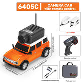 Orange and white remote control camera car with accessories, USB cable, and carrying case.