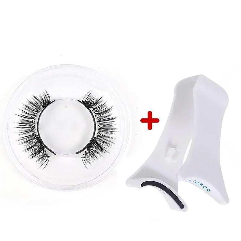 Black synthetic false eyelashes with white plastic applicator tool on white background