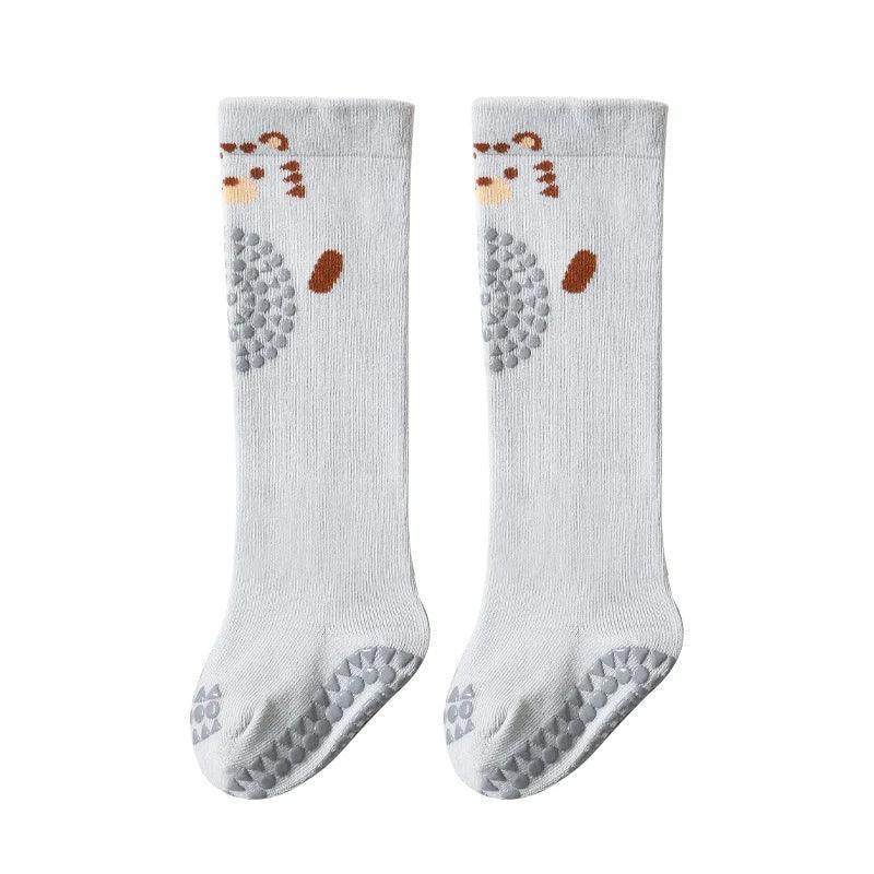White cotton knee-high socks with bear face design and anti-slip grips, kids fit.