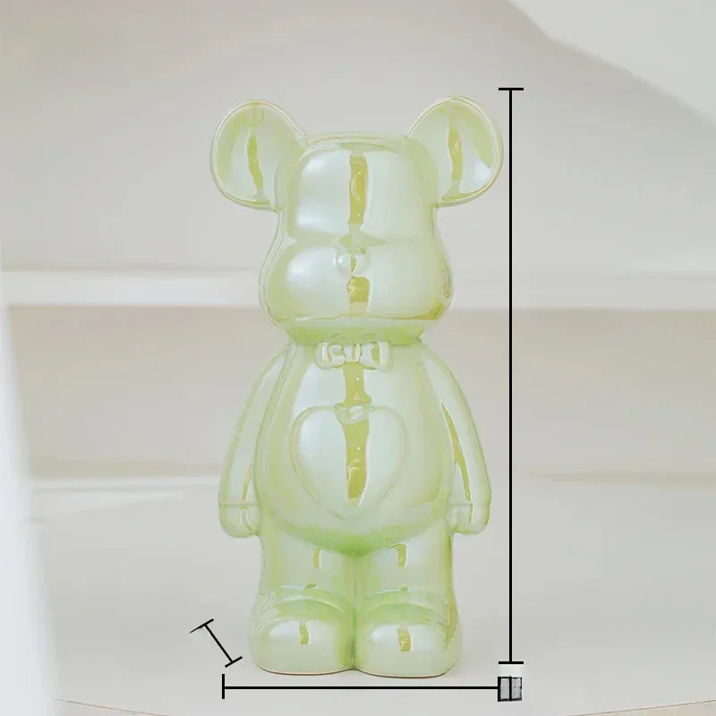 Glossy light green ceramic bear figurine with measuring lines on a neutral background
