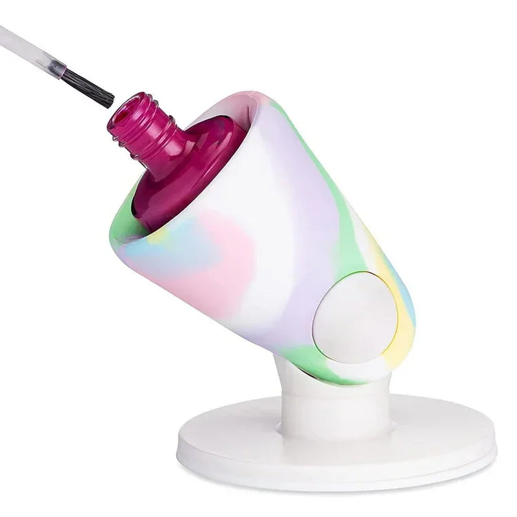 Pastel rainbow silicone nail polish bottle holder with open magenta polish and brush