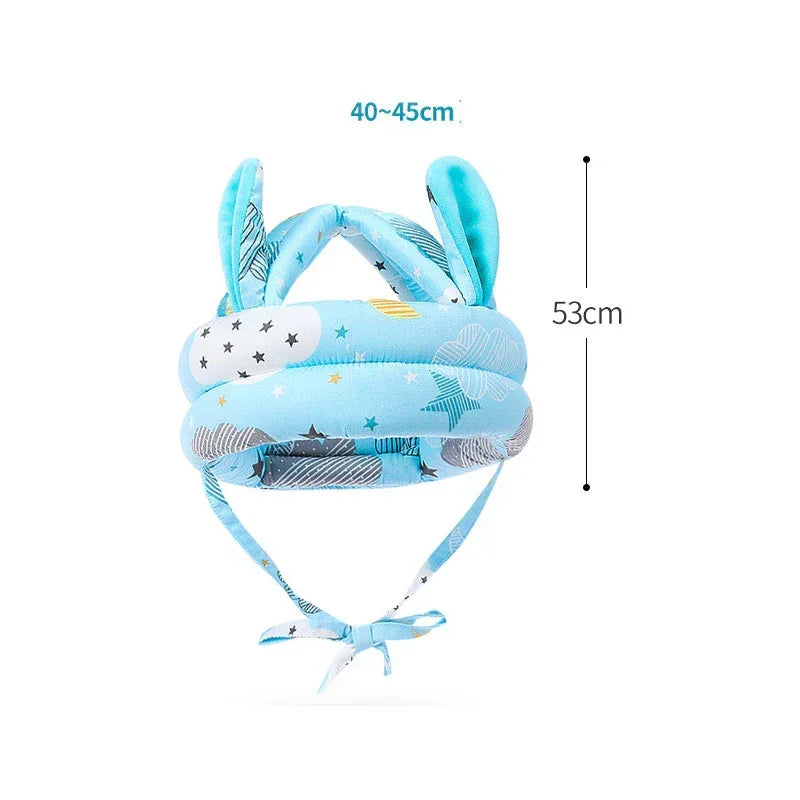 Blue baby safety helmet with cloud and star print, soft fabric, adjustable fit, ear details