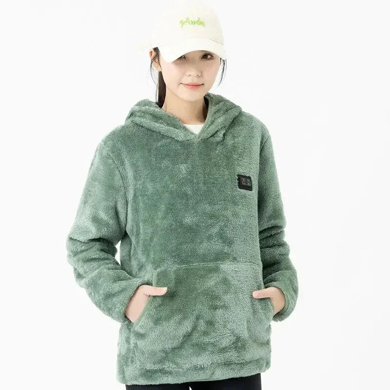 Woman wearing loose fit sage green plush fleece hoodie with front pocket and hood