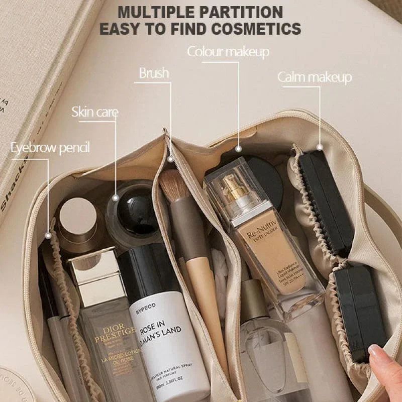 Beige cosmetic bag with organized compartments holding skincare, makeup, and brushes.