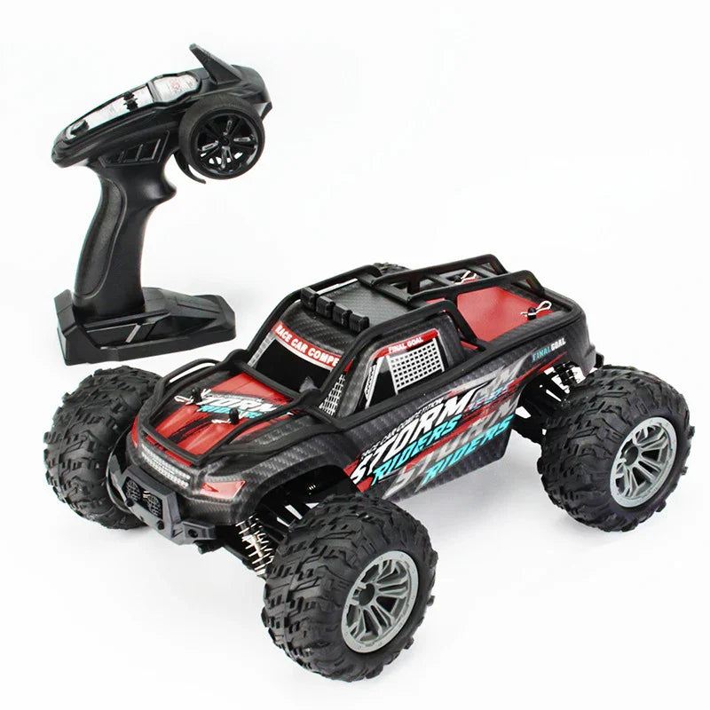 Red and black RC off-road truck with large tires and remote controller on white background